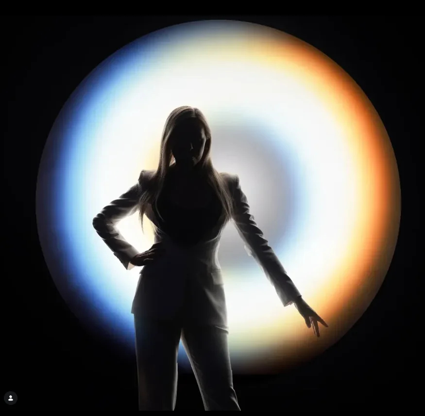 Sylwetka kobiety na tle świetlnego koła